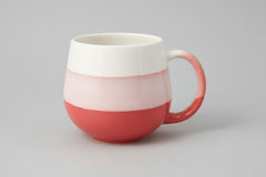White mug with red accent on a white background